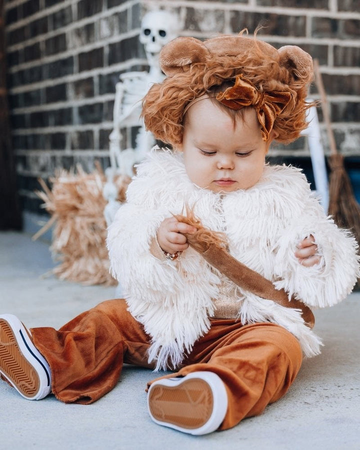 Sea Dragon Dreams ivory faux shag layered jacket worn by a toddler with a brown velvet bow headband