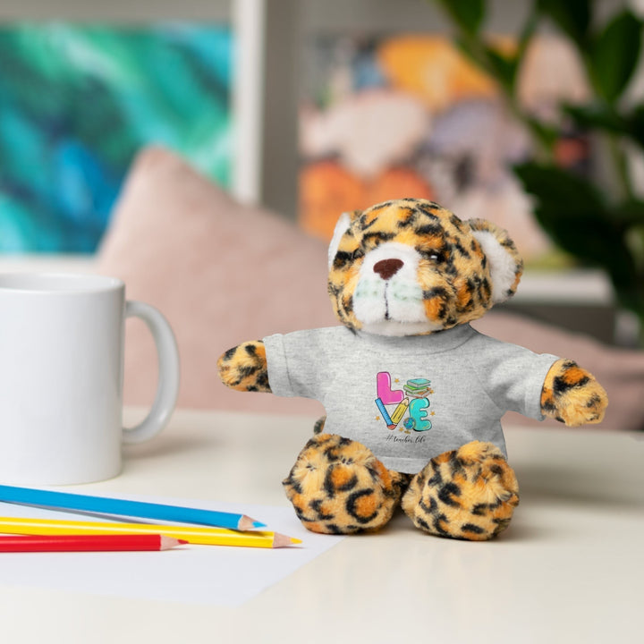 Sea Dragon Dreams plush jaguar stuffed animal wearing a grey cotton t-shirt with Love Teacher Life graphic design