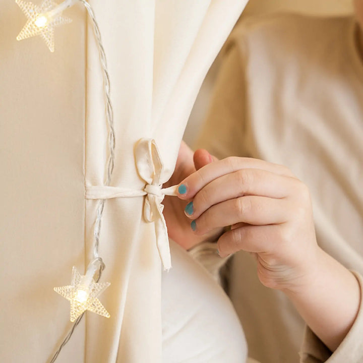 Sea Dragon Dreams Tiny Land kids play tent in cream fabric with glowing star fairy lights tied back by a ribbon