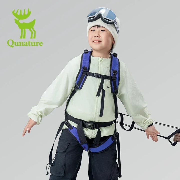 Sea Dragon Dreams Qunature H53 kids ski training backpack with blue harness and traction rope on a young skier
