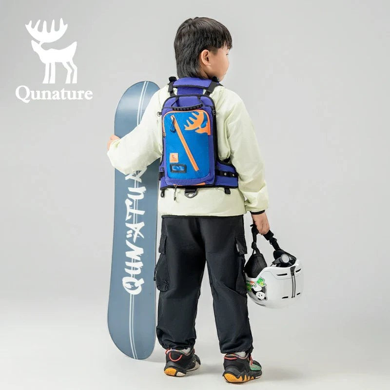 Sea Dragon Dreams Qunature H53 kids ski training backpack in blue with orange accents, worn by a child with a snowboard
