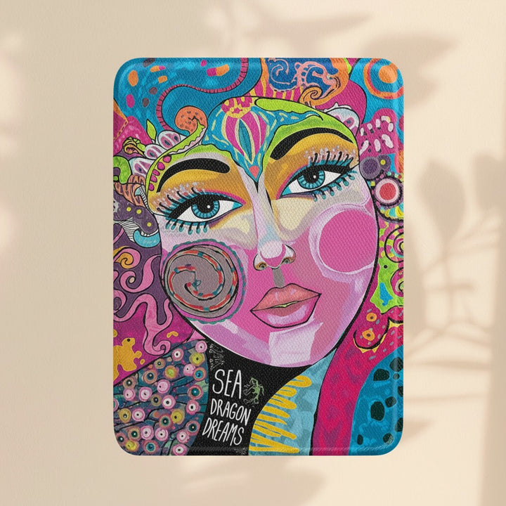 Sea Dragon Dreams Kindle Paperwhite case featuring vibrant bohemian art with a stylized face and colorful patterns.