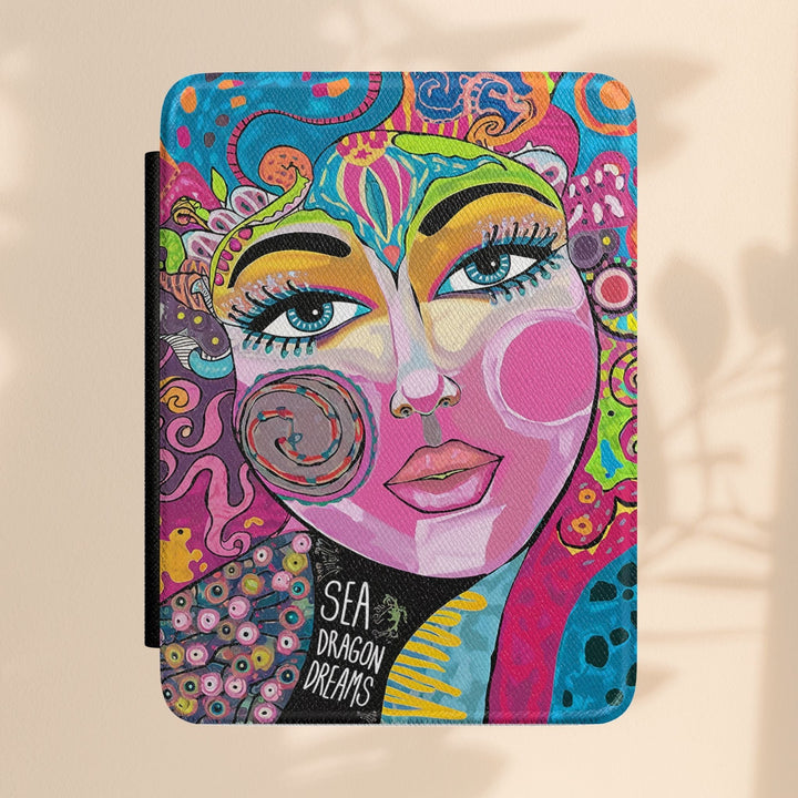 Sea Dragon Dreams Kindle Paperwhite case featuring vibrant bohemian art with a stylized face and colorful patterns.