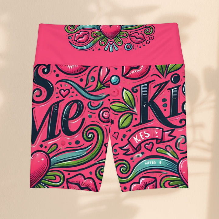 Sea Dragon Dreams high-waisted workout shorts in pink with a playful Kiss Me motif, hearts, and swirling floral patterns.