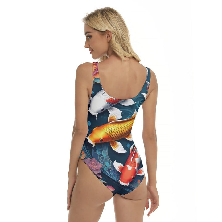 Back view of a woman wearing a Sea Dragon Dreams one-piece swimsuit with a vibrant koi fish and floral pattern.