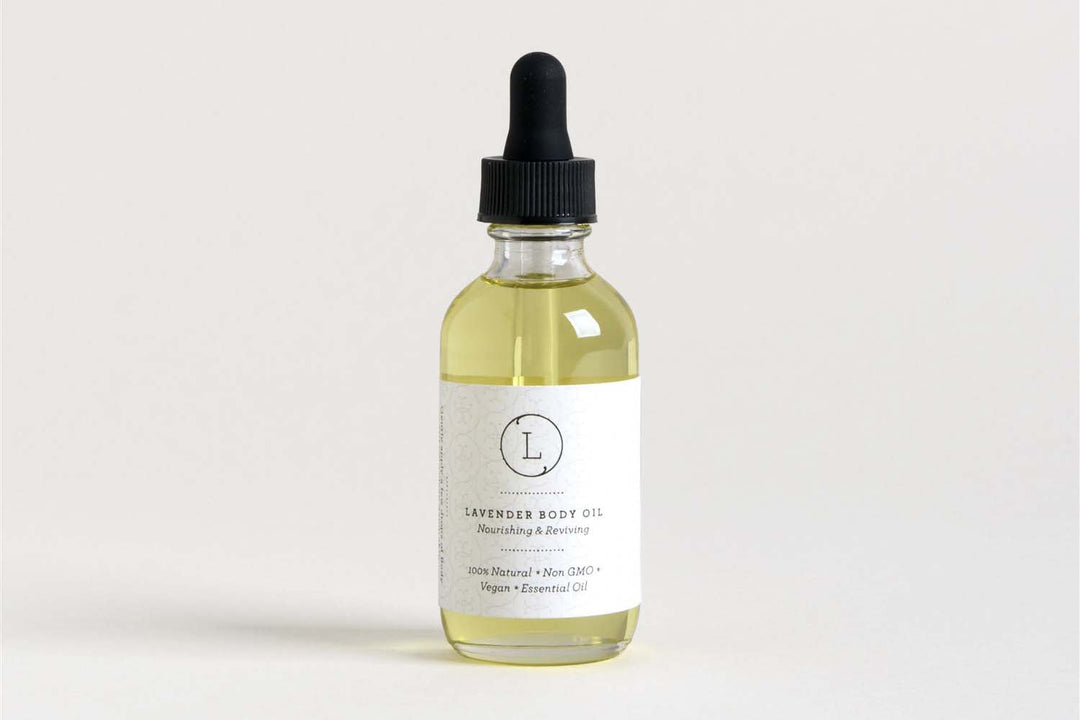 Sea Dragon Dreams lavender body oil in a glass dropper bottle with a white label, featuring natural vegan ingredients.