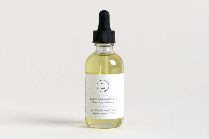 Sea Dragon Dreams lavender body oil in a glass dropper bottle with a white label, featuring natural vegan ingredients.