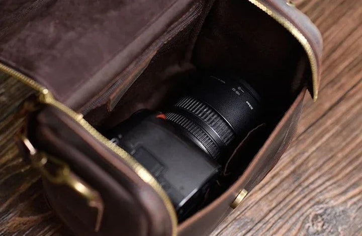 Sea Dragon Dreams Calista handcrafted brown full-grain leather camera bag holding a DSLR camera with lens