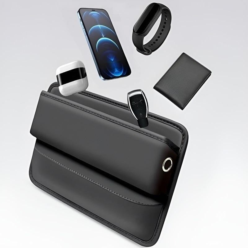 Sea Dragon Dreams black PU leather car seat gap organizer holding a smartphone, wallet, and accessories.