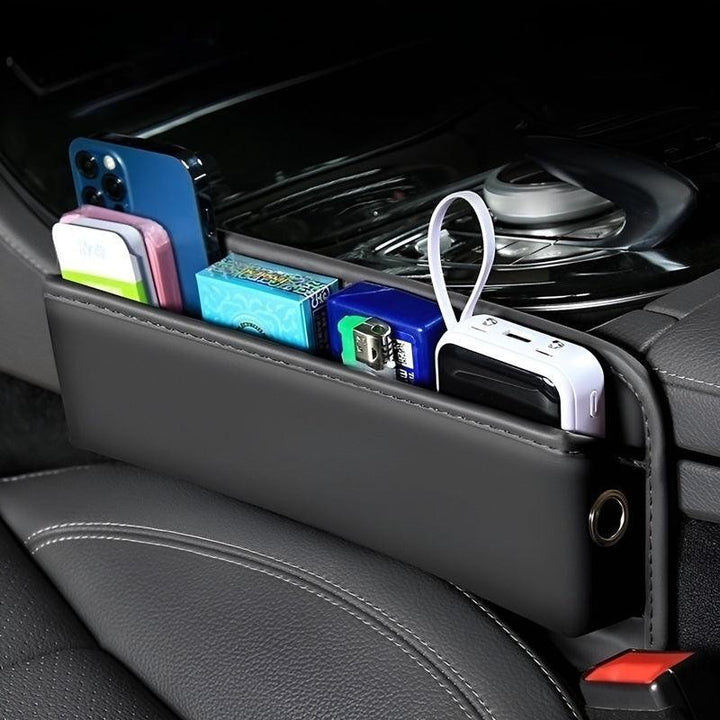 Sea Dragon Dreams black PU leather car seat gap organizer holding a smartphone, wallet, and accessories in a vehicle.