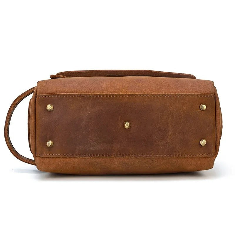 Sea Dragon Dreams brown leather toiletry bag bottom view with protective brass feet and side carry handle