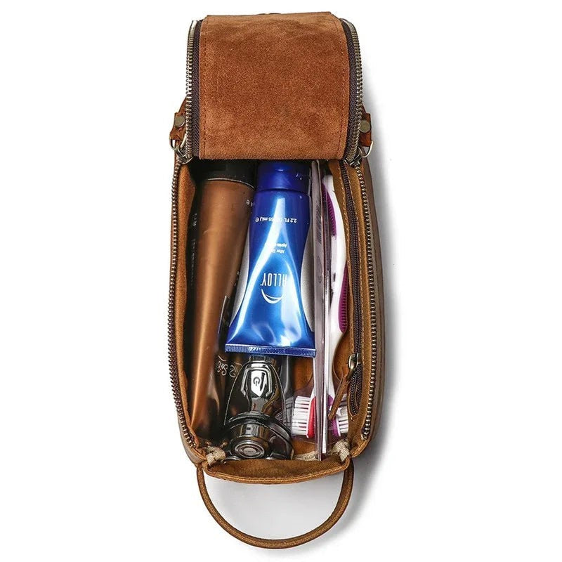 Sea Dragon Dreams handmade brown leather toiletry bag open with travel essentials and grooming items inside