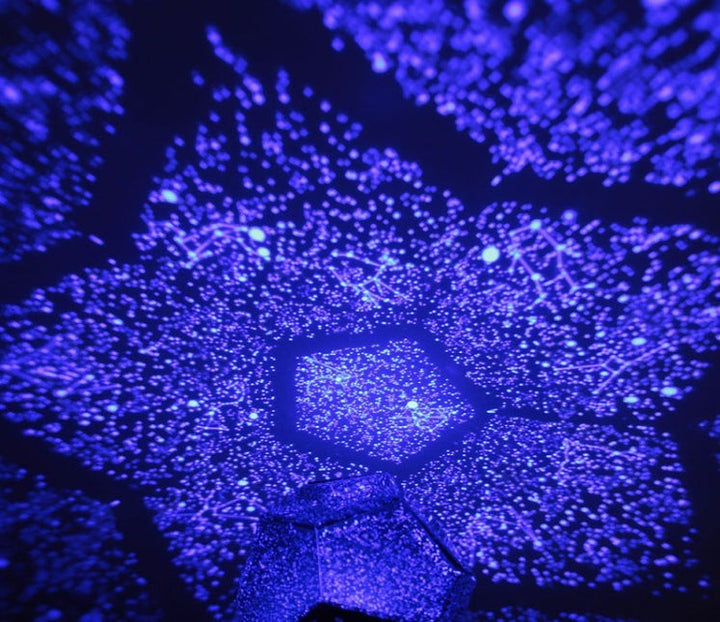 Sea Dragon Dreams LED star projector lamp casting a vibrant blue constellation pattern on a dark ceiling