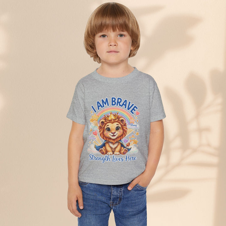 Child wearing a grey Sea Dragon Dreams cotton t-shirt featuring a Leo Lion graphic and I Am Brave text