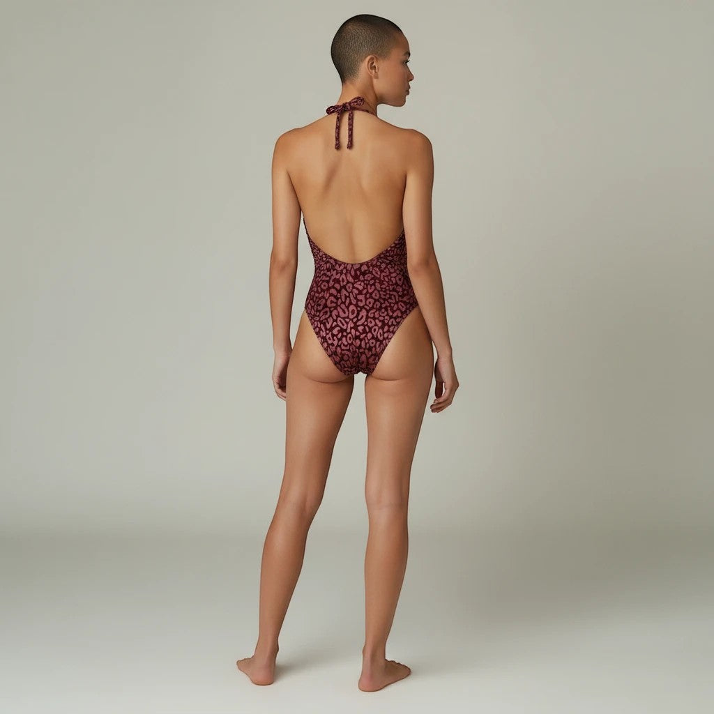 Sea Dragon Dreams leopard print halter one-piece swimsuit with an open back design on a model, rear view.
