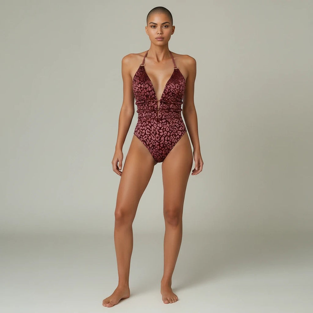 Sea Dragon Dreams leopard print halter one-piece swimsuit with a deep V-neck and backless design on a model.