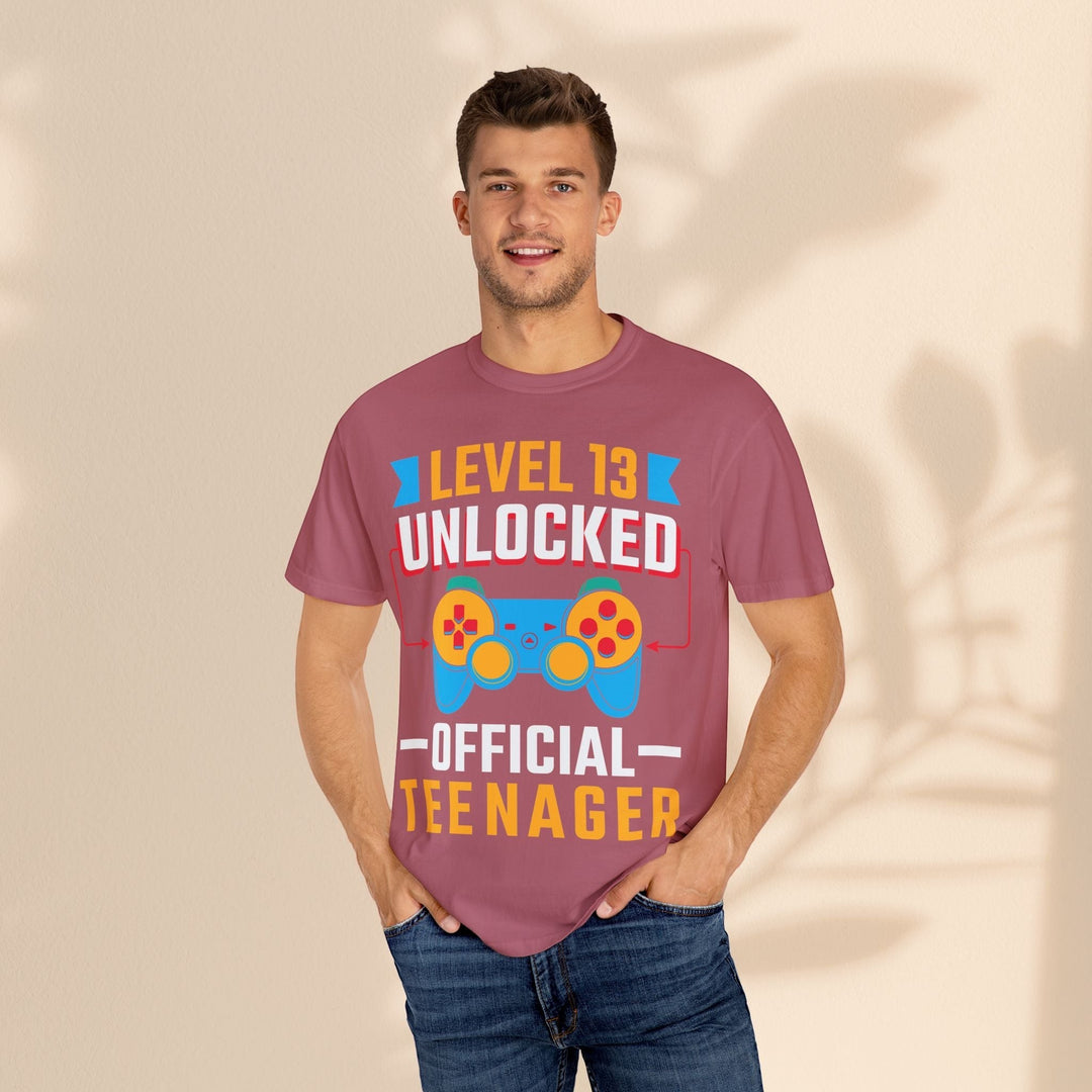 Sea Dragon Dreams Level 13 Unlocked gamer t-shirt in mauve cotton worn by a man with blue jeans.