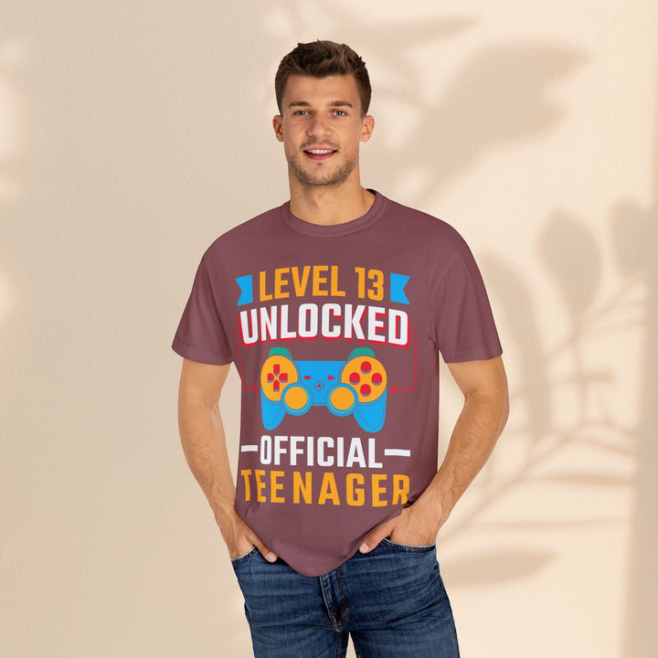 Sea Dragon Dreams unisex gamer t-shirt in maroon cotton with Level 13 Unlocked graphic worn by a smiling man