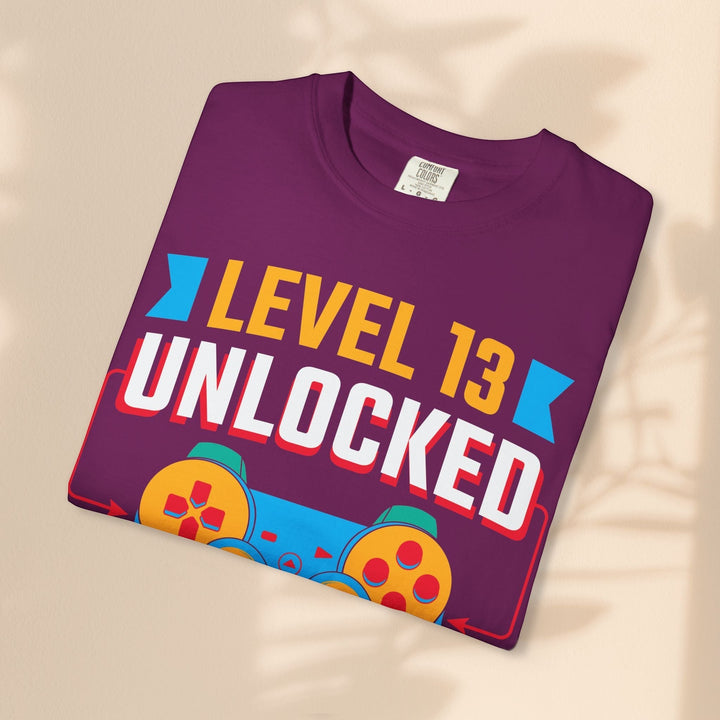 Sea Dragon Dreams Level 13 Unlocked gamer t-shirt in plum cotton with a retro blue and orange controller graphic
