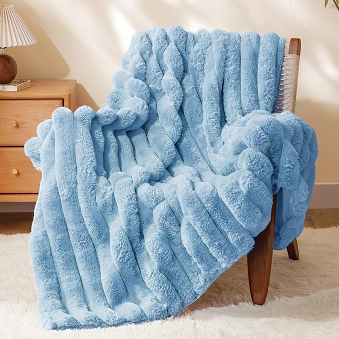Sea Dragon Dreams BEDELITE light blue faux rabbit fur throw blanket with 3D striped texture draped over a wooden chair