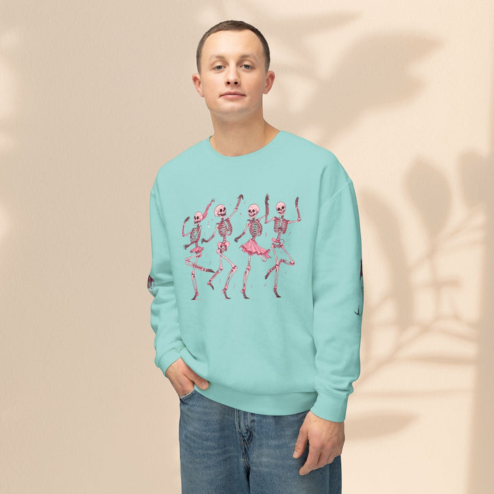 Man wearing a Sea Dragon Dreams light blue crewneck sweatshirt with a pink dancing skeletons graphic print.