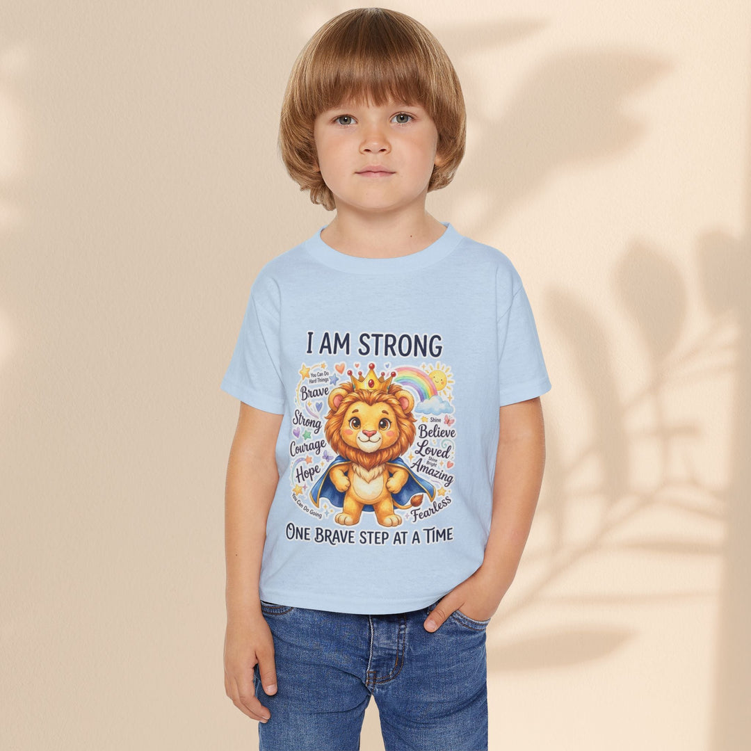 Sea Dragon Dreams toddler t-shirt in light blue cotton featuring a courageous lion graphic with I Am Strong text.