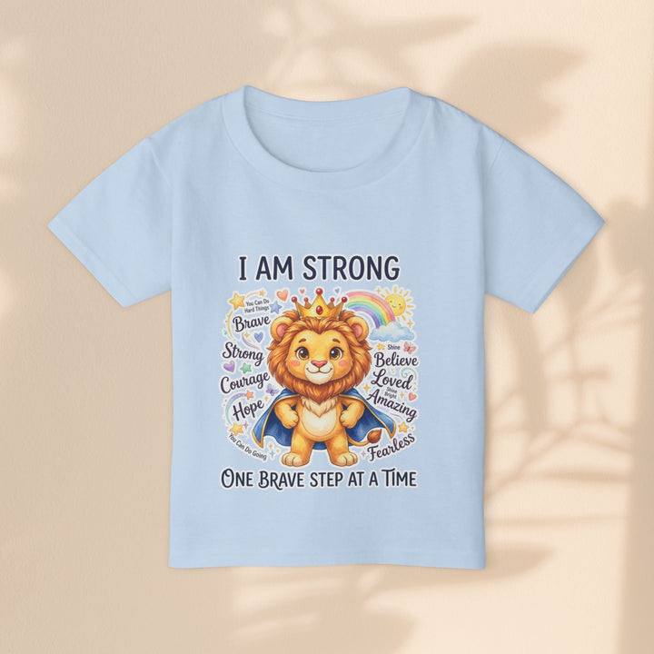 Sea Dragon Dreams light blue toddler t-shirt featuring a courageous lion illustration and I Am Strong text.