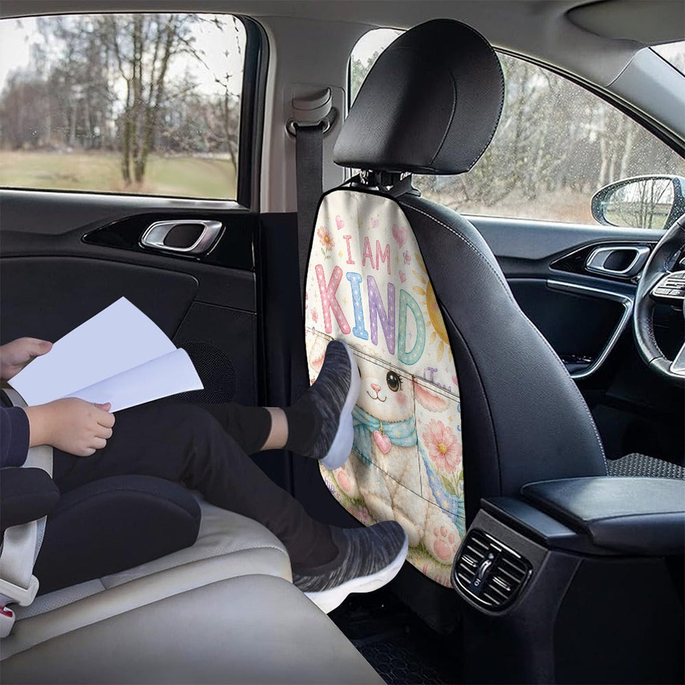 Sea Dragon Dreams car seat back storage bag with a cute llama print and I AM KIND text, installed in a vehicle.