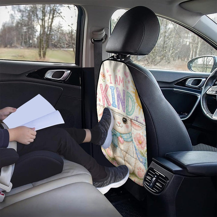 Sea Dragon Dreams car seat back storage bag with a cute llama print and I AM KIND text, installed in a vehicle.