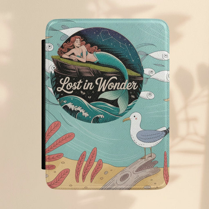 Sea Dragon Dreams Lost in Wonder Kindle case with a mermaid illustration, seagull, and textured black spine.