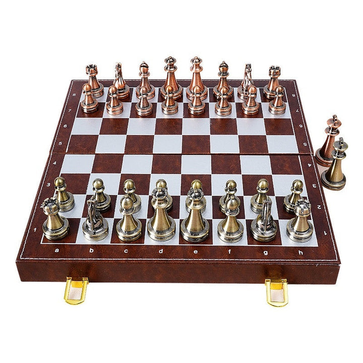 Sea Dragon Dreams portable magnetic chess set with metallic bronze and silver pieces on a folding brown board