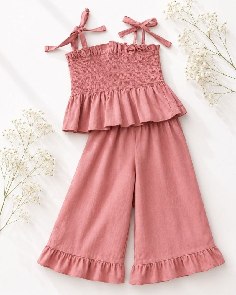 Sea Dragon Dreams Maisie two-piece set in pressed peony pink with smocked top, tie straps, and ruffled wide-leg pants.