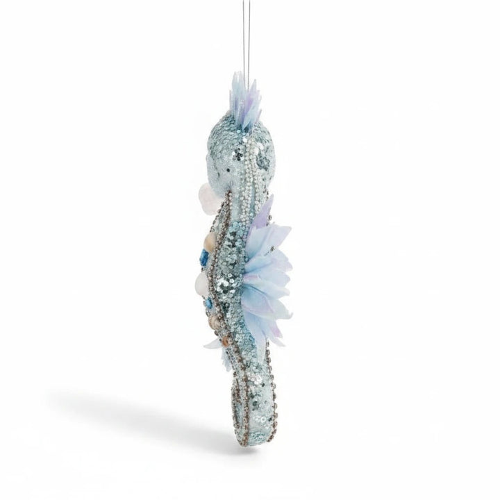 Sea Dragon Dreams Mark Roberts blue seahorse ornament with iridescent fins, glitter, sequins, beads, and sea shells.