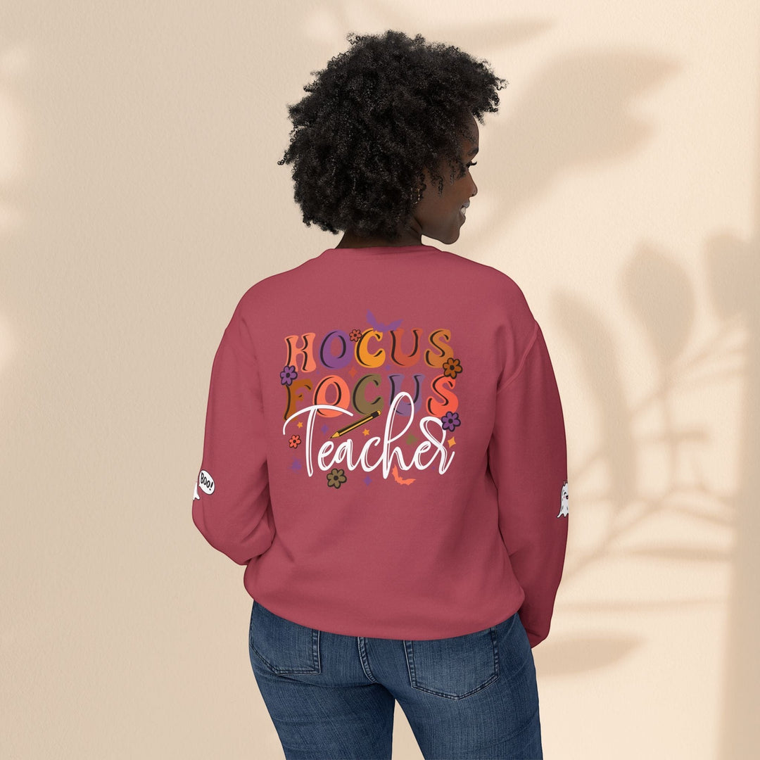 Sea Dragon Dreams unisex crewneck sweatshirt in maroon with Hocus Focus Teacher graphic on the back, worn by a model.