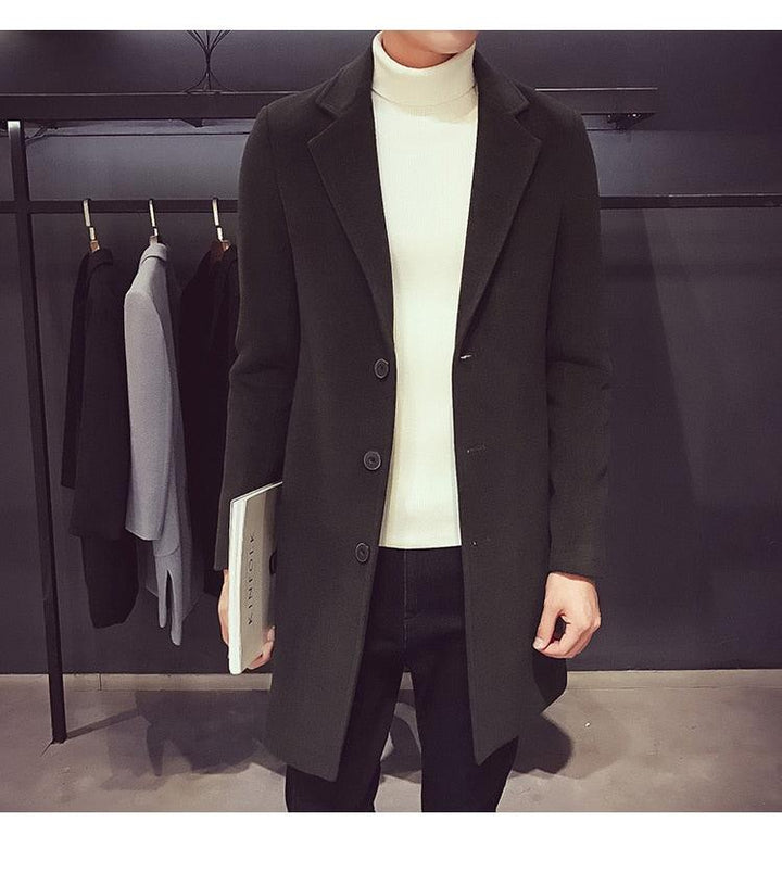 Sea Dragon Dreams men's dark green cotton trench coat with a turn-down collar worn over a white turtleneck sweater.