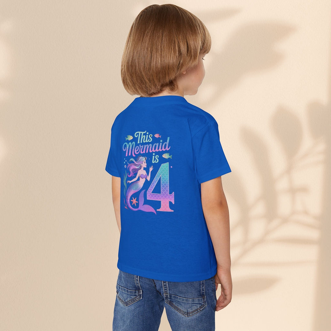 Sea Dragon Dreams toddler t-shirt in blue with a mermaid 4th birthday graphic on the back, worn by a child.