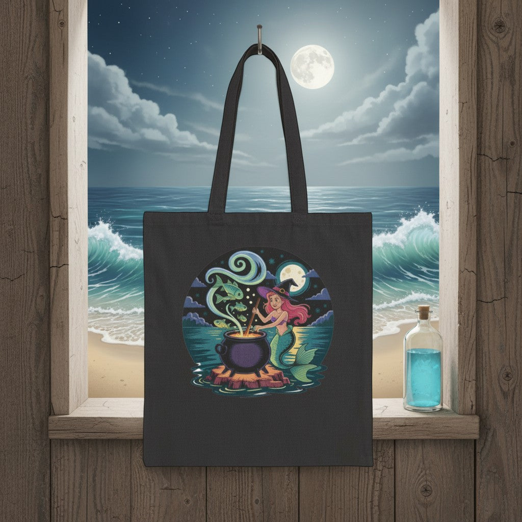 Sea Dragon Dreams black cotton canvas tote bag featuring a whimsical mermaid stirring a magical cauldron at night.