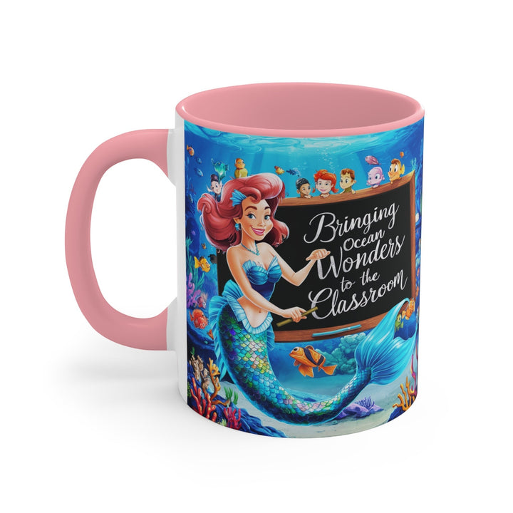 Sea Dragon Dreams ceramic accent mug featuring a mermaid teacher and ocean classroom design with a pink handle.