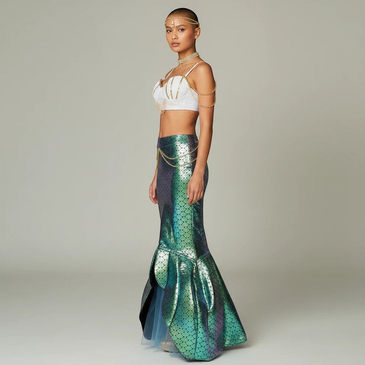 Sea Dragon Dreams mermaid costume with white sequin shell top, gold chains, and iridescent green tail skirt on model