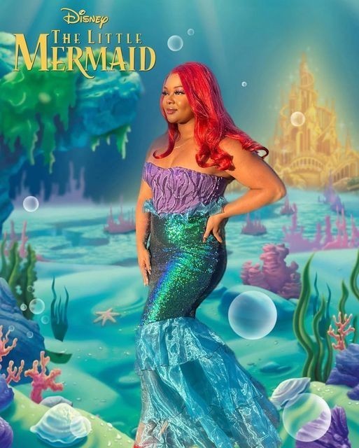 Sea Dragon Dreams mermaid costume featuring a purple corset and shimmering green sequin skirt with organza layers.