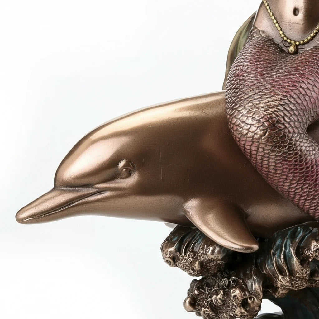 Sea Dragon Dreams polystone mermaid and dolphin figurine featuring a bronze finish and detailed wave base