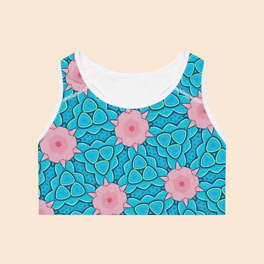 Sea Dragon Dreams Mermaid’s Garden sports bra featuring a blue and pink floral ocean-inspired seamless pattern.