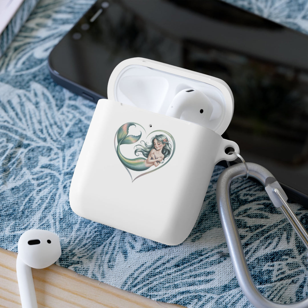 Sea Dragon Dreams white TPU AirPods case with a mermaid heart illustration and a metal carabiner on a patterned mat.
