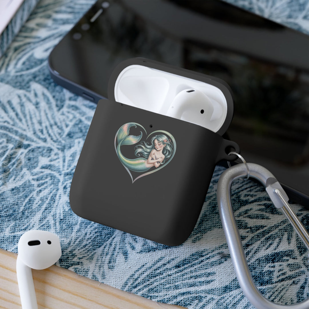 Sea Dragon Dreams mermaid heart protective AirPods case in black with a metal carabiner on a blue patterned surface.