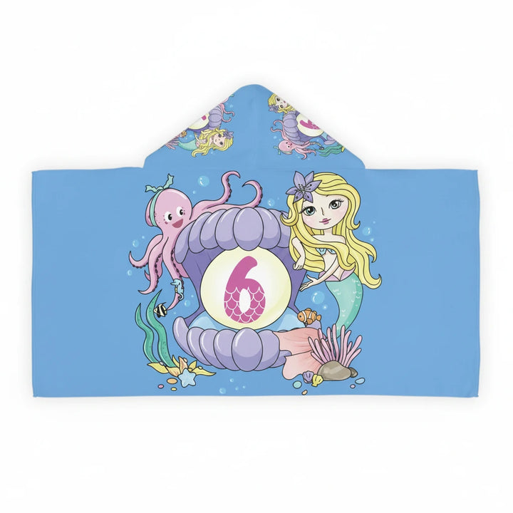 Sea Dragon Dreams kids hooded towel with mermaid, octopus, and number 6 seashell print on a blue background.