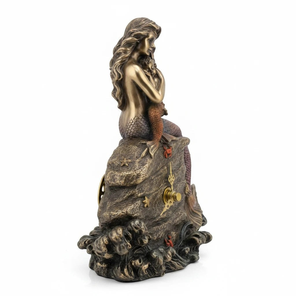 Sea Dragon Dreams mermaid mother and baby clock featuring a bronze-toned sculpted figure on a rocky ocean wave base.