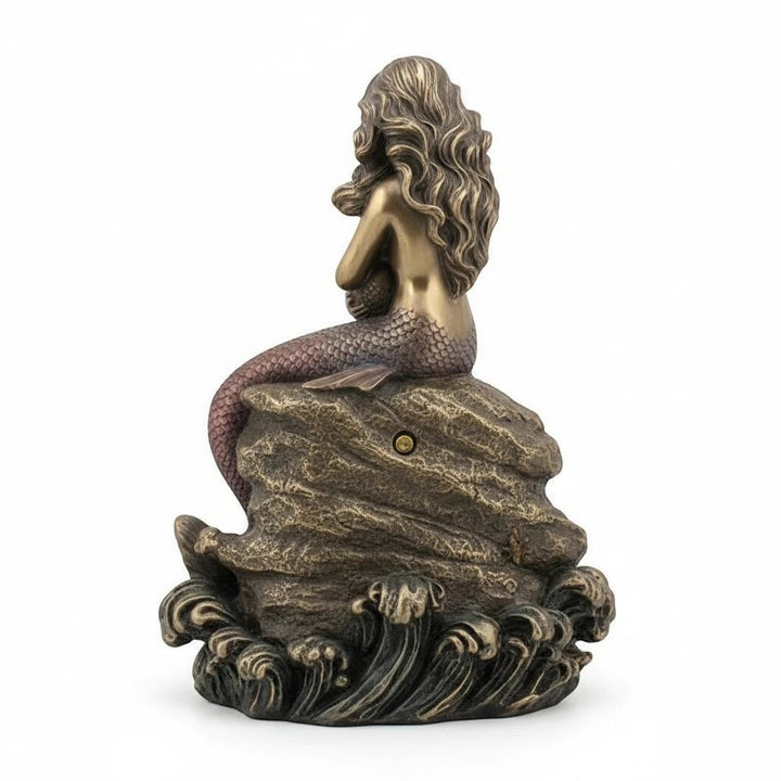 Sea Dragon Dreams mermaid mother and baby clock seen from the back, featuring a bronze-toned sculpted rock and waves.