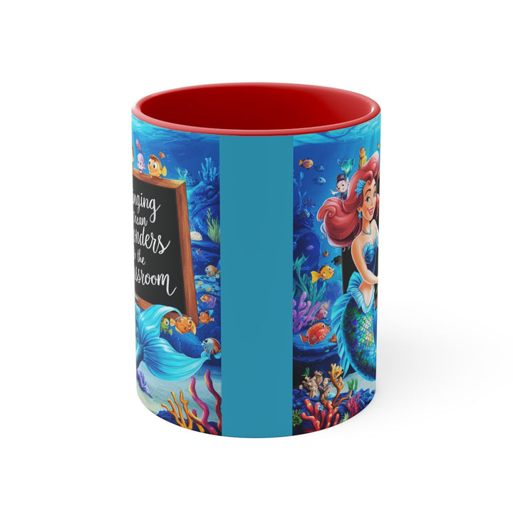 Sea Dragon Dreams ceramic mug with red interior featuring a vibrant mermaid and ocean classroom illustration.