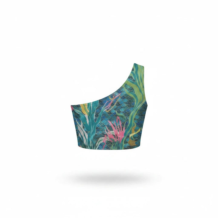 Sea Dragon Dreams one-shoulder cropped top featuring a blue mermaid scale and underwater coral reef print.