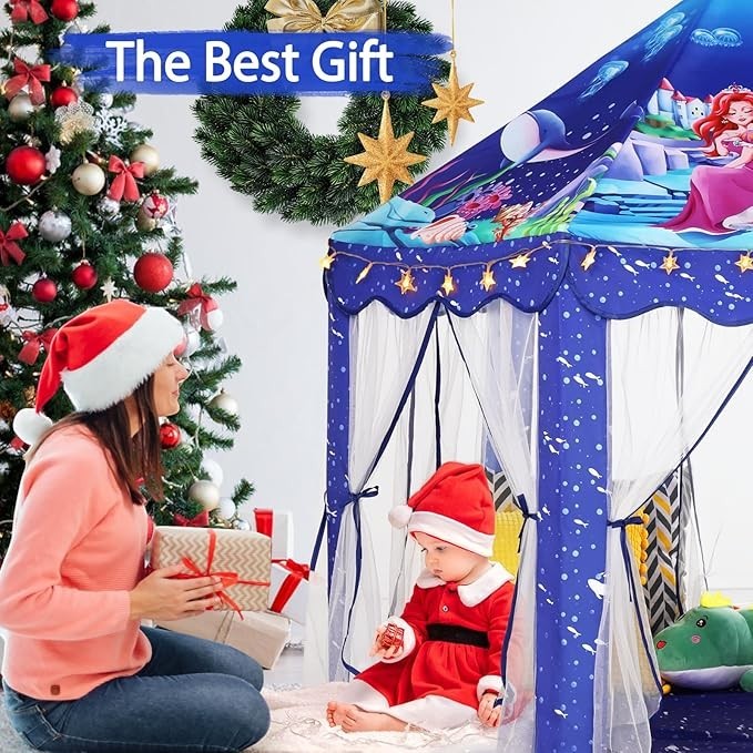 Sea Dragon Dreams blue mermaid princess play tent with star lights, featuring a child inside near a Christmas tree.